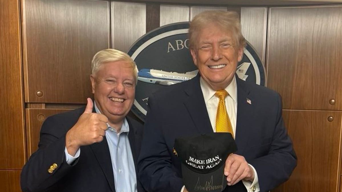 Sen. Lindsey Graham gives thumbs up as President Donald Trump holds "MAKE IRAN GREAT AGAIN" CAP