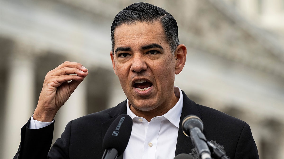 Robert Garcia stands at podium.