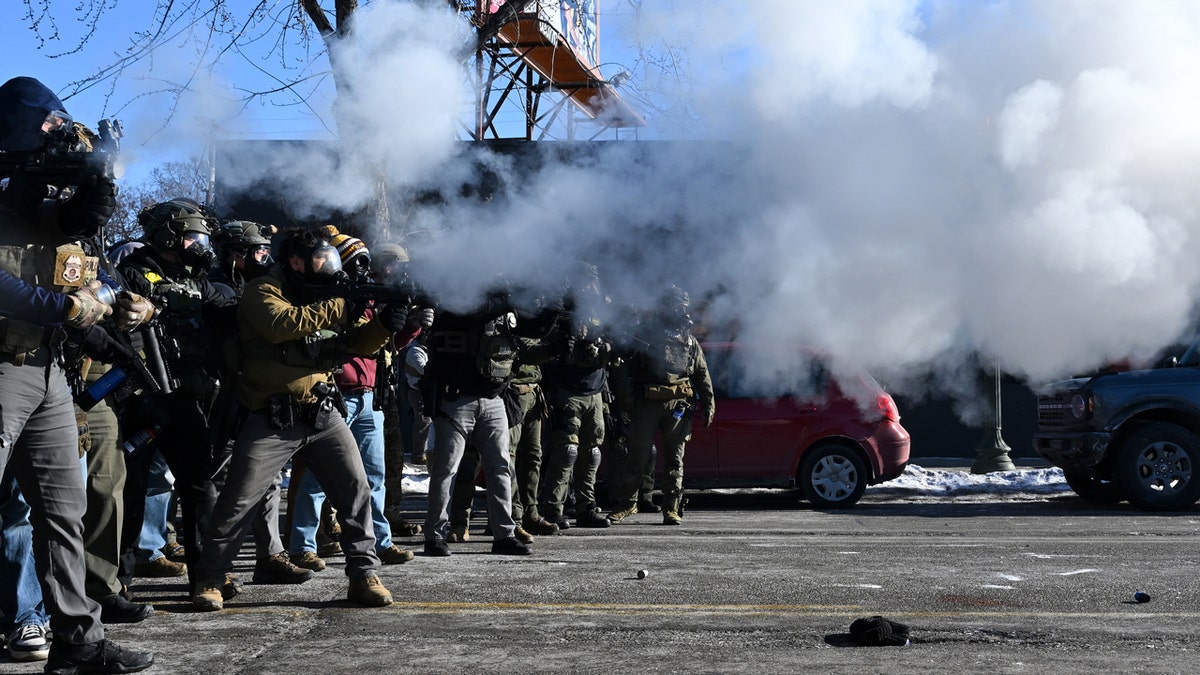 Federal agents fire tear gas.