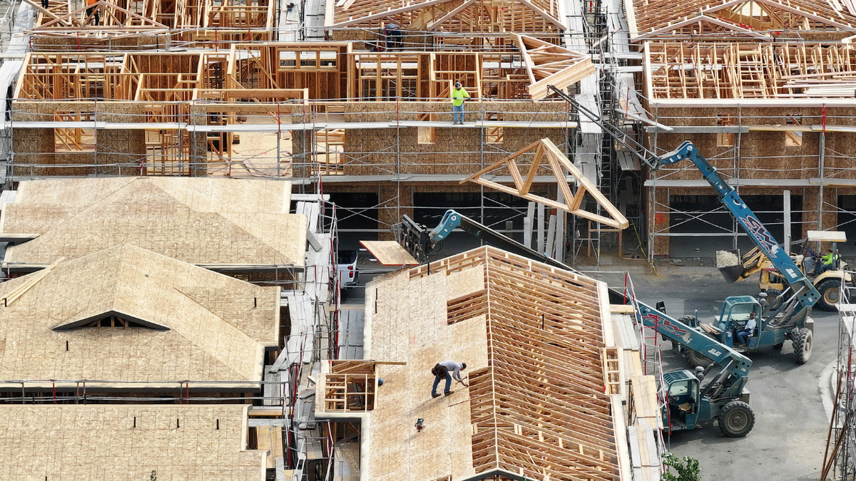 Workers are seen building homes in California.