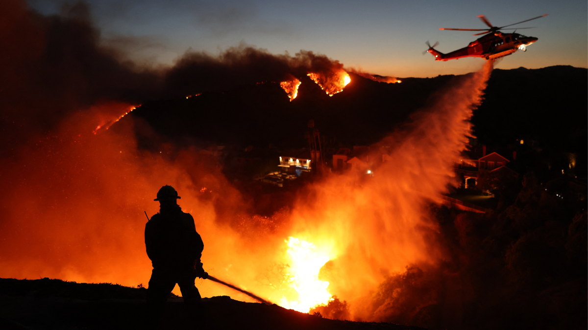 Fire personnel respond to a wildfire in the Pacific Palisades.