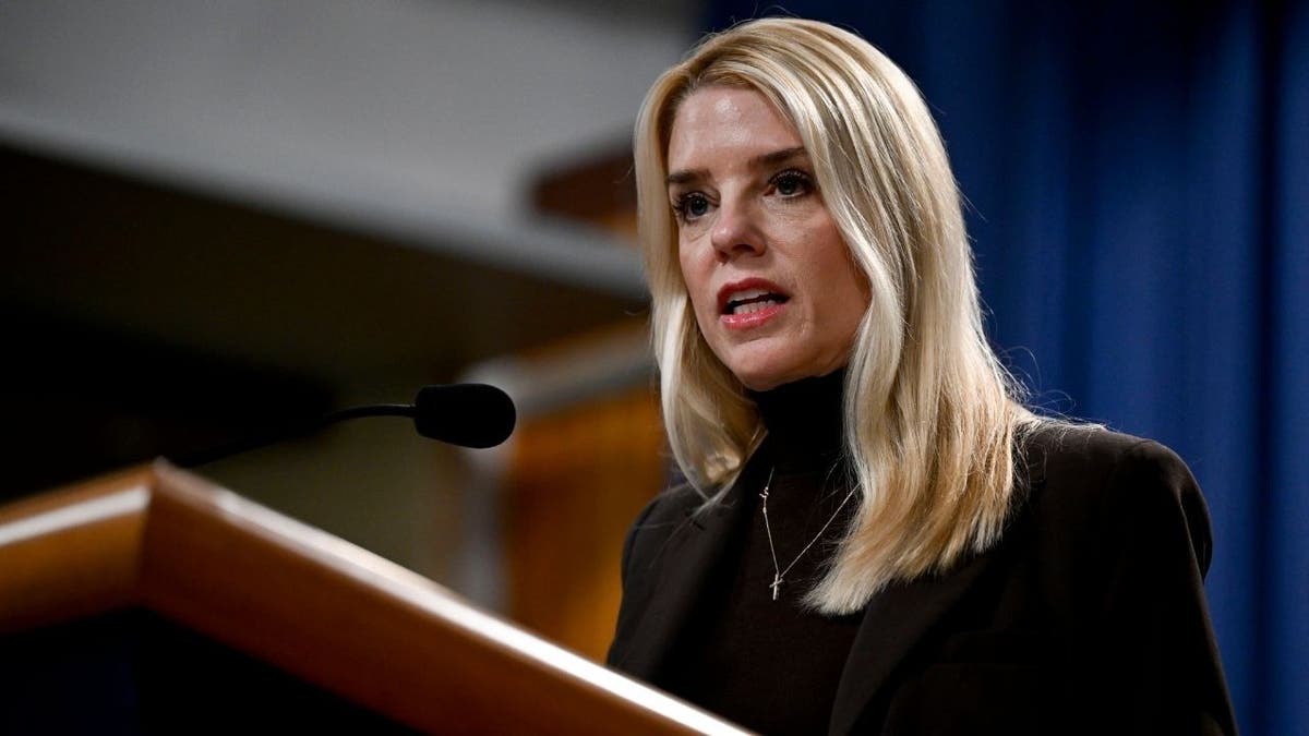 Pam Bondi stands at a podium
