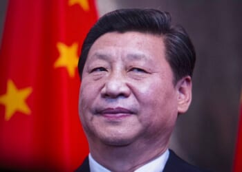 Xi Jinping in front of a Chinese flag.