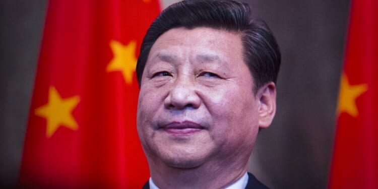 Xi Jinping in front of a Chinese flag.