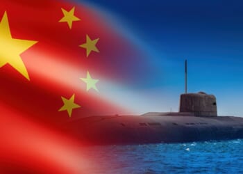 A Chinese submarine against a Chinese flag backdrop.