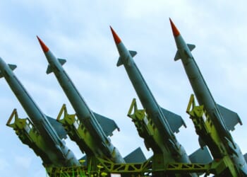 A group of four anti-air missiles pointed at the sky.
