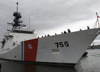 A US Coast Guard Legend-class cutter at a dock.