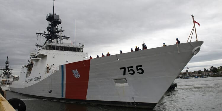 A US Coast Guard Legend-class cutter at a dock.