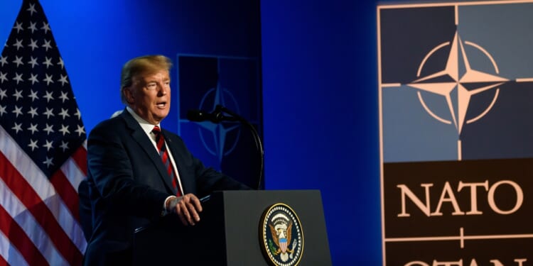 Trump giving a speech at a NATO summit.