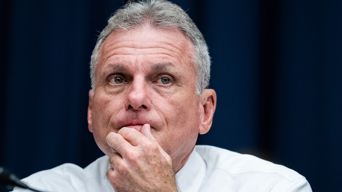 Congressman Buddy carter sits contemplatively in committee