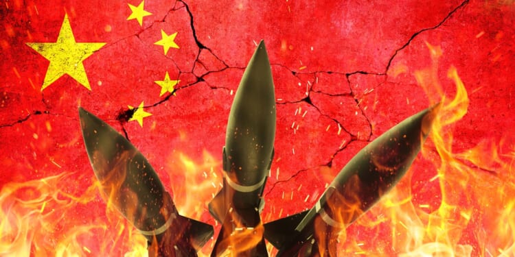 A group of Chinese nuclear missiles against a Chinese flag backdrop.