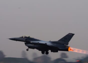 A fighter jet taking off.