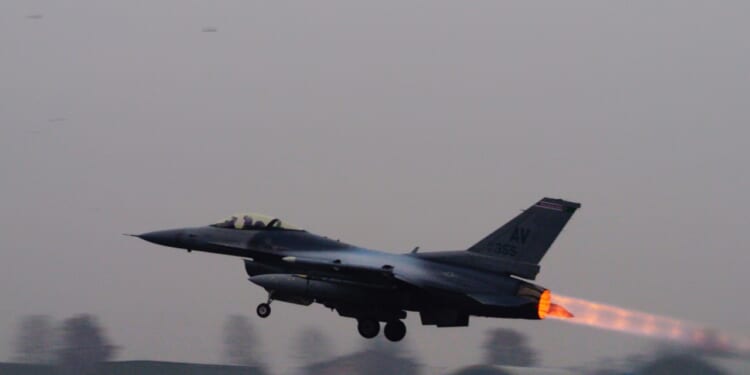 A fighter jet taking off.