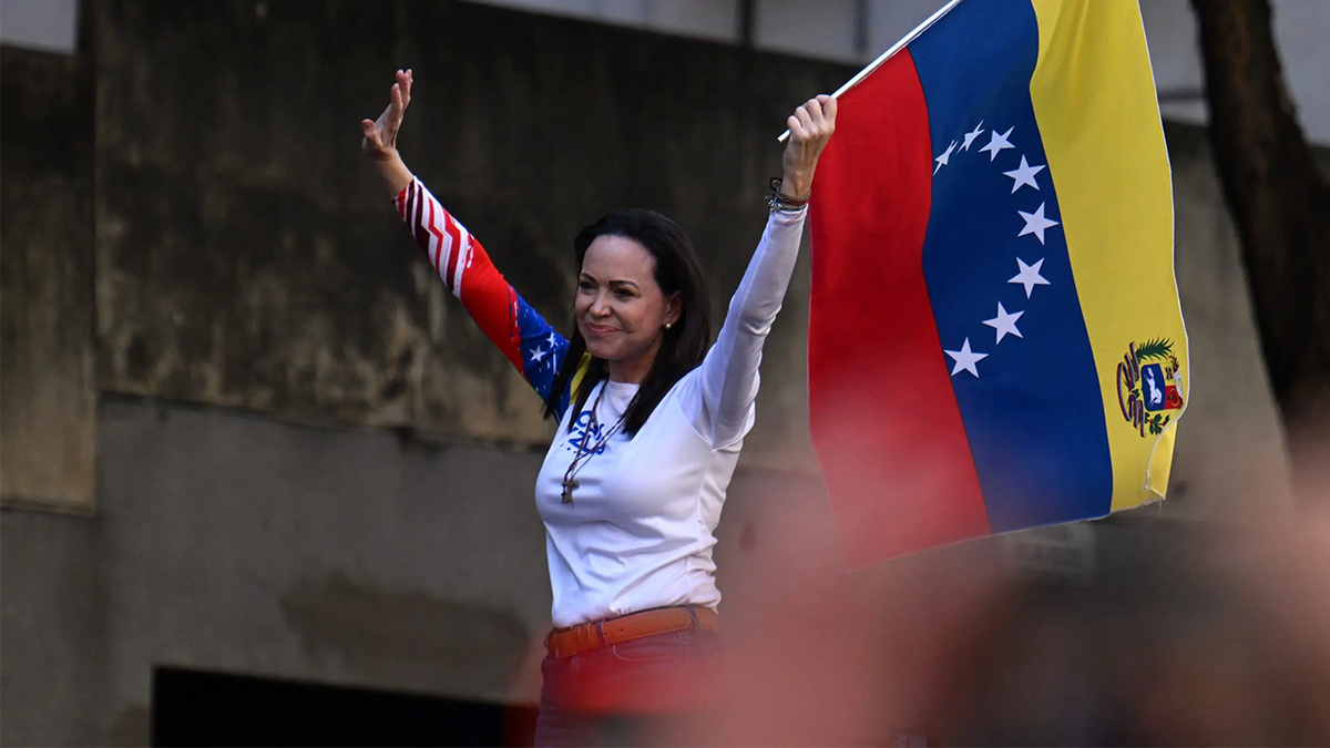 Venezuelan opposition leader Maria Corina Machado waves a national flag during a protest called by the opposition on the eve of the presidential inauguration, in Caracas on January 9, 2025.