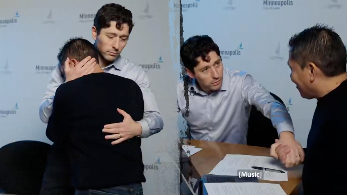 Minneapolis Mayor Jacob Frey hugs a man during an interview with a local Latino radio station criticizing ICE.