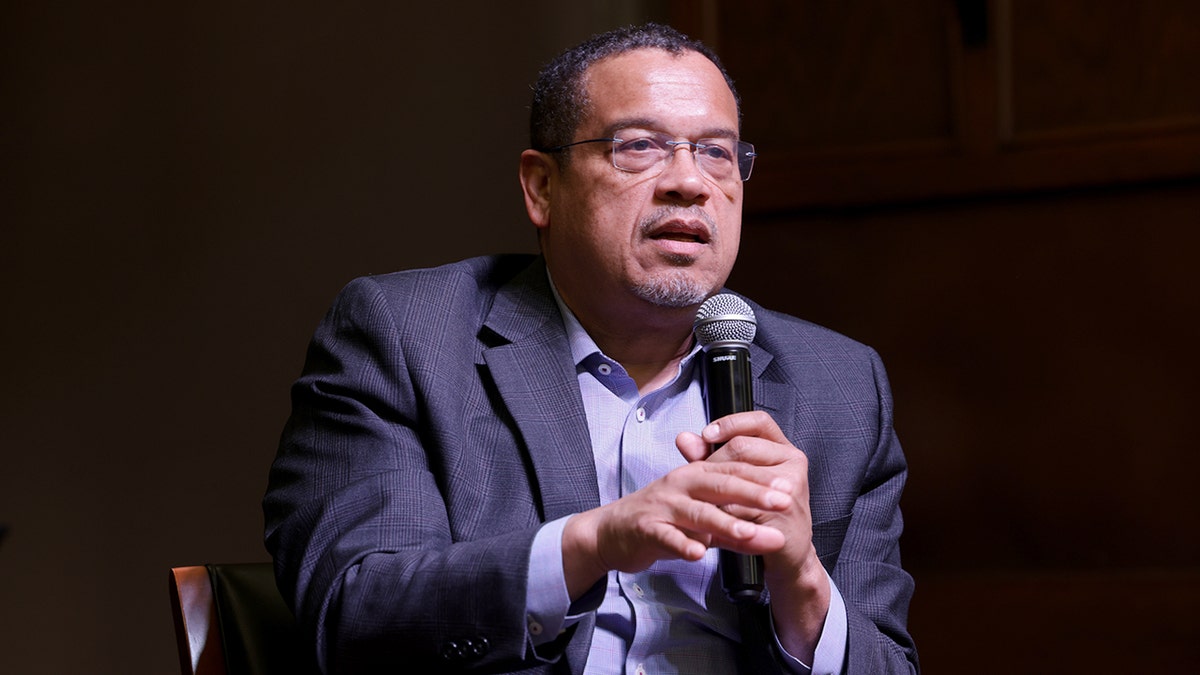 Minnesota Attorney General Keith Ellison holds microphone as he speaks