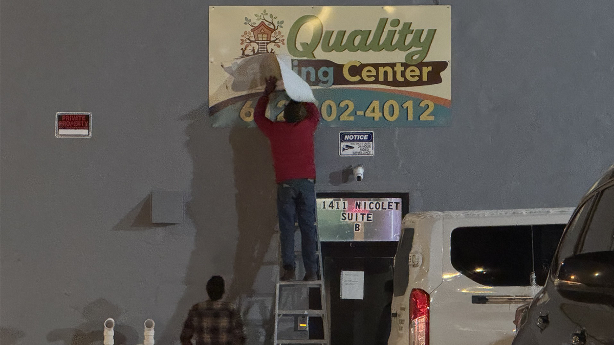 Quality Learning Center sign being corrected