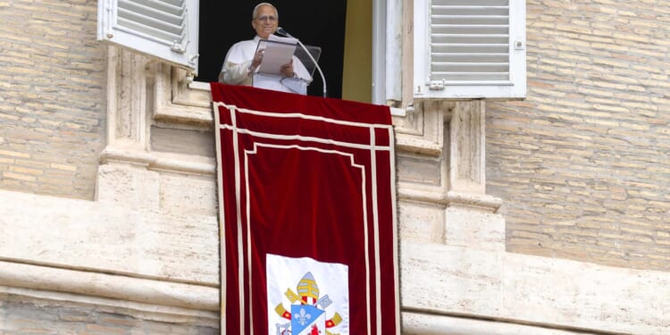 Pope Leo XIV speaks from a window of the Apostolic Palace overlooking St. Peter’s Square during the Sunday Angelus on Aug. 24, 2025.