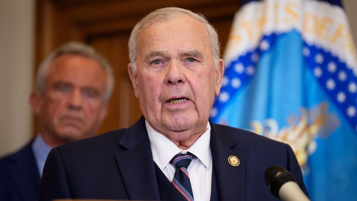 Rep. Jim Baird speaks at the U.S. Department of Agriculture as Robert F. Kennedy Jr. stands behind him.