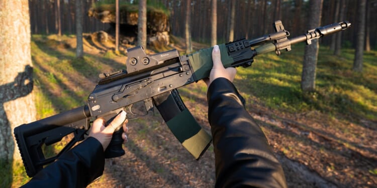 A person holding an AK-12 assault rifle.