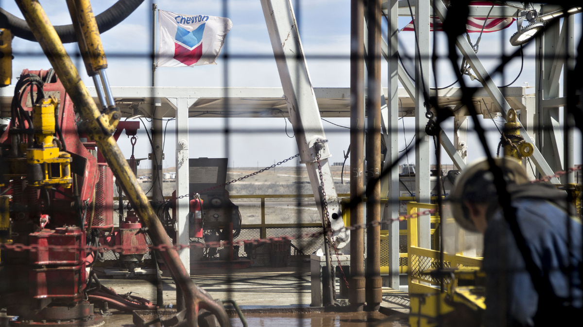 A Chevron flag is seen flying above a drilling platform in Midland, Texas.