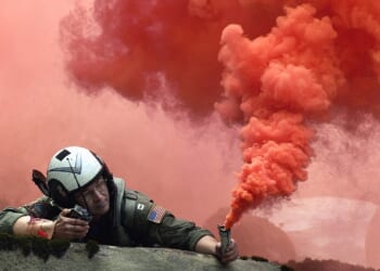 A pilot lighting a flare.