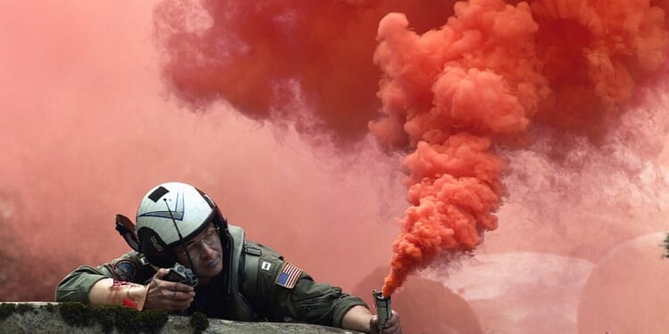 A pilot lighting a flare.