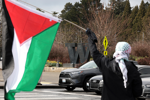 A person holds a Palestinian flag