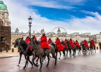 A group of British ceremonial guards on horseback.
