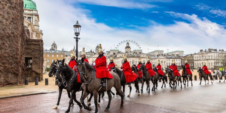 A group of British ceremonial guards on horseback.