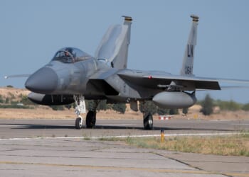 An F-15 fighter jet on a runway.
