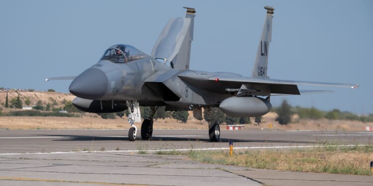An F-15 fighter jet on a runway.