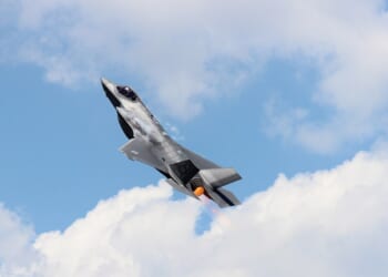 An F-35 ascending in the sky.