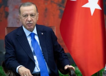 Recep Tayyip Erdogan leaning back in his seat.
