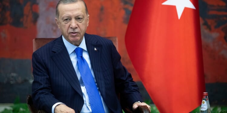 Recep Tayyip Erdogan leaning back in his seat.