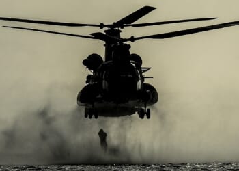 A soldier rappelling from a helicopter.