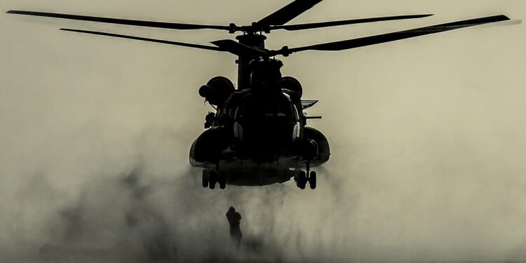 A soldier rappelling from a helicopter.