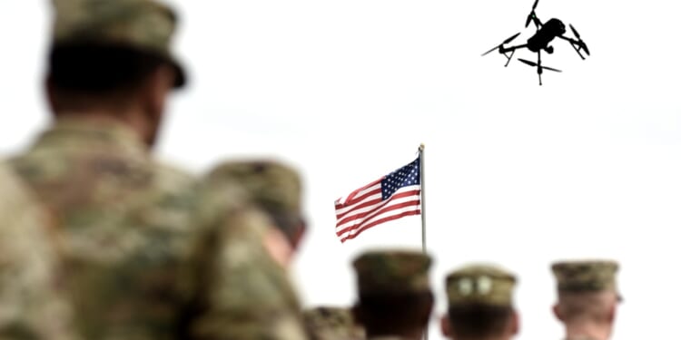 A group of US soldiers with a drone overhead.