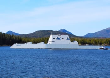 A Zumwalt-class destroyer near the coast.