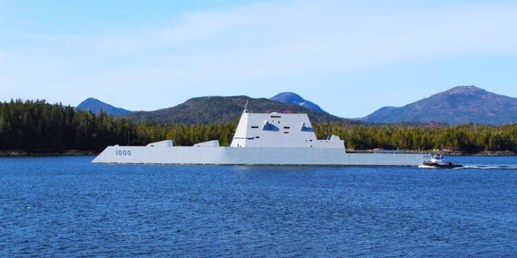 A Zumwalt-class destroyer near the coast.