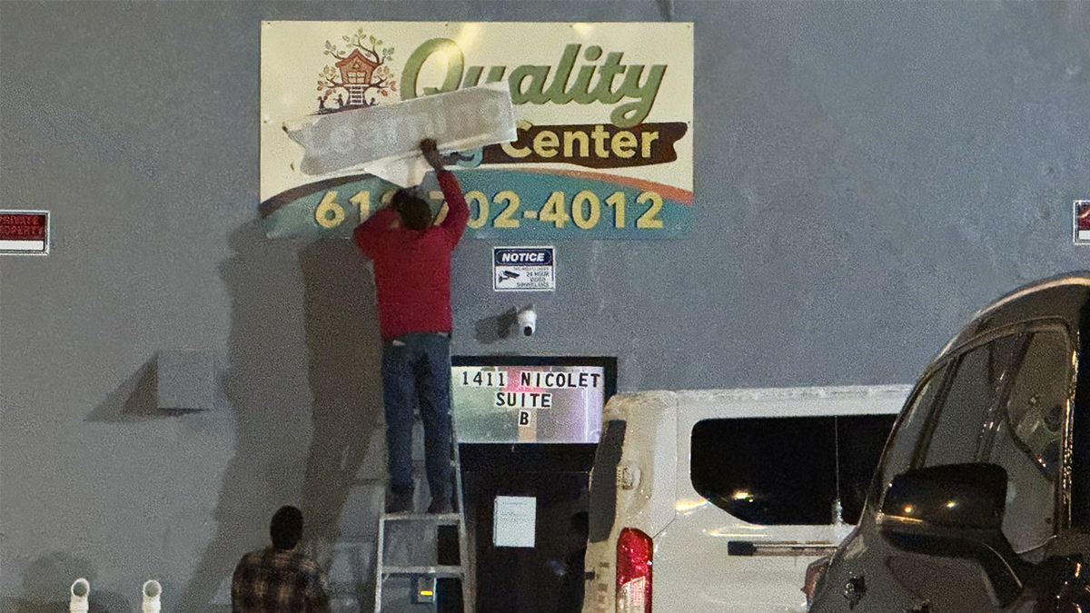 Quality Learning Center sign being fixed