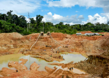 Gold mining place in Guyana, local indigenous people clear workspace from stones and check it for gold nuggets. Amazon and Essequibo basin deforestation. Guyana, Brazil, Venezuela gold mining deforestation.