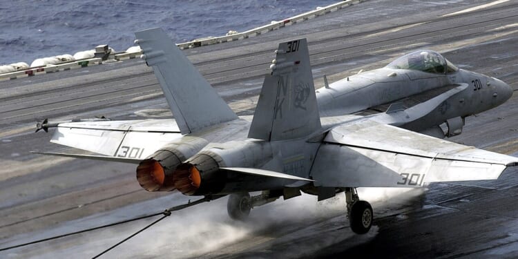 An F/A-18 Hornet landing on an aircraft carrier.