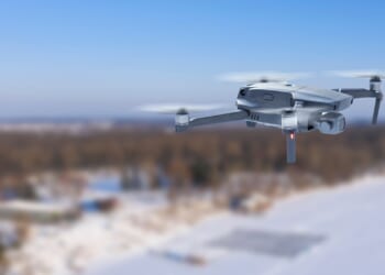 A drone flying over a snowy landscape.