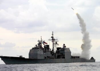 A Navy ship firing a missile.