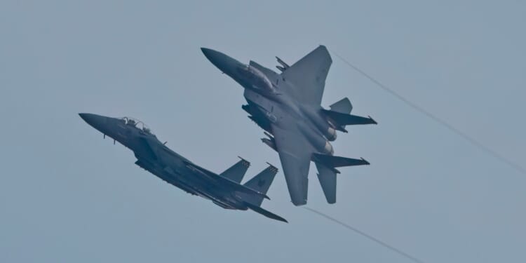 Two F-15s in flight.