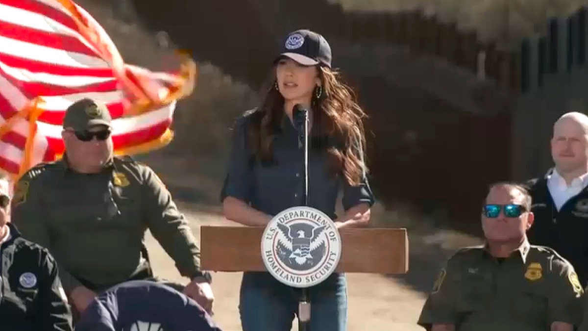 Kristi Noem speaking at a microphone