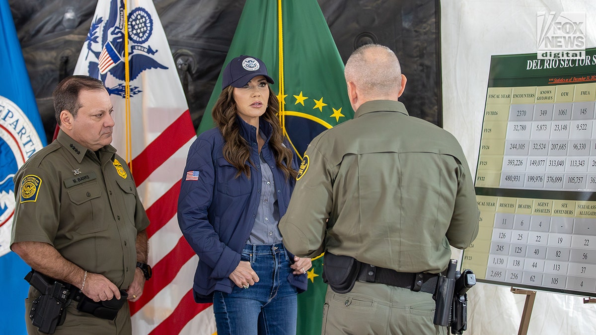 Kristi Noem standing with CBP officials outdoors in Eagle Pass, Texas