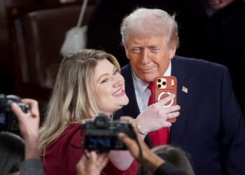 Rep Kat Cammack sits with Dems on left side of House chamber at Trump address
