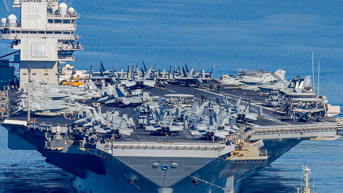 The USS Gerald R. Ford aircraft carrier sailing away from the coast of Crete.